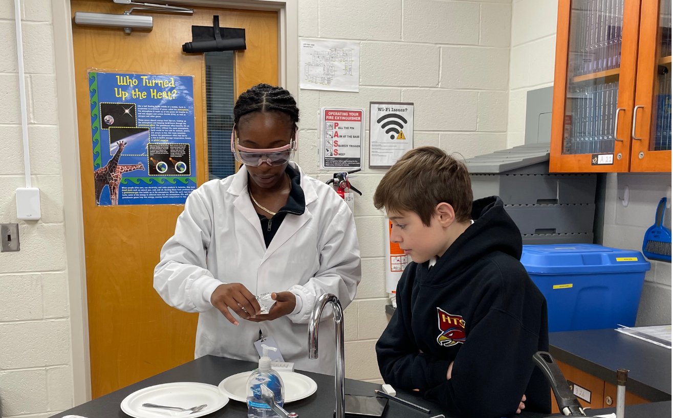 teacher teaching a student in a science lab